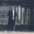 Gaya berpakaian musim dingin dengan long coat krem dan syal rajut yang stylish