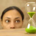 Ibu sedang menerapkan cara mengajarkan anak sabar menggunakan timer visual di meja makan