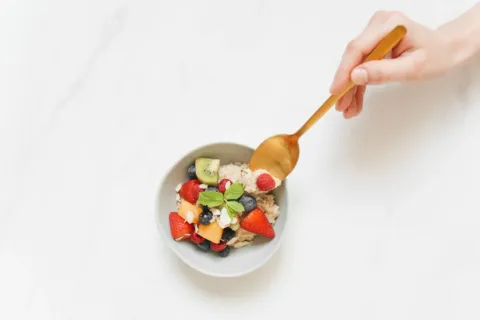 Menu kebiasaan sarapan sehat berisi oatmeal potongan pisang dan telur rebus di atas meja
